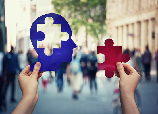 2 hands holding puzzle pieces