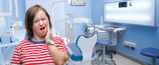 woman in dental office with tooth pain