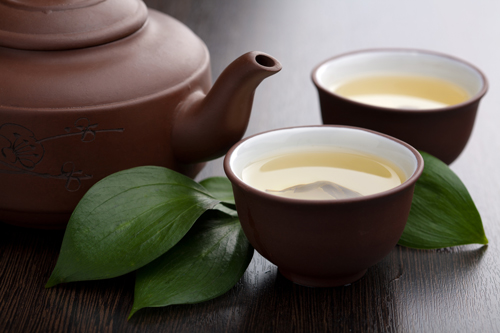 teapot and cups with green tea