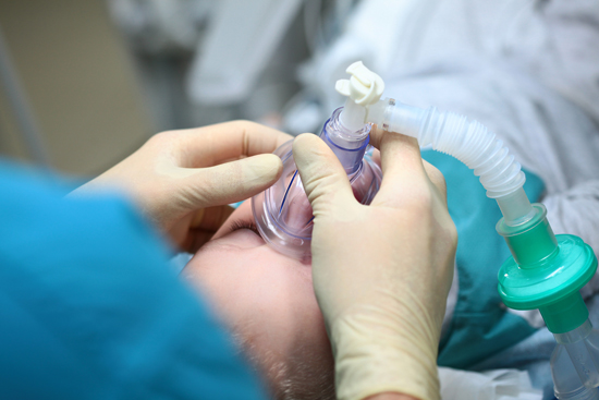 anaesthetist holding a mask