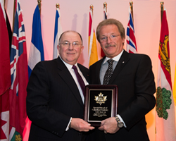 Mr. Lyle Best holding an award