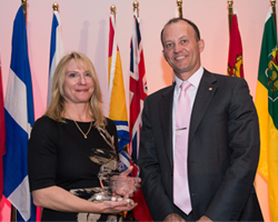 Ms. Michele Brenning and Dr. Peter Doig holding an award