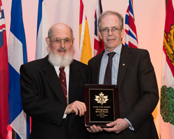 Dr. Colin Dawes holding an award