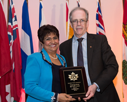 Dr. Saida Rasul holding an award